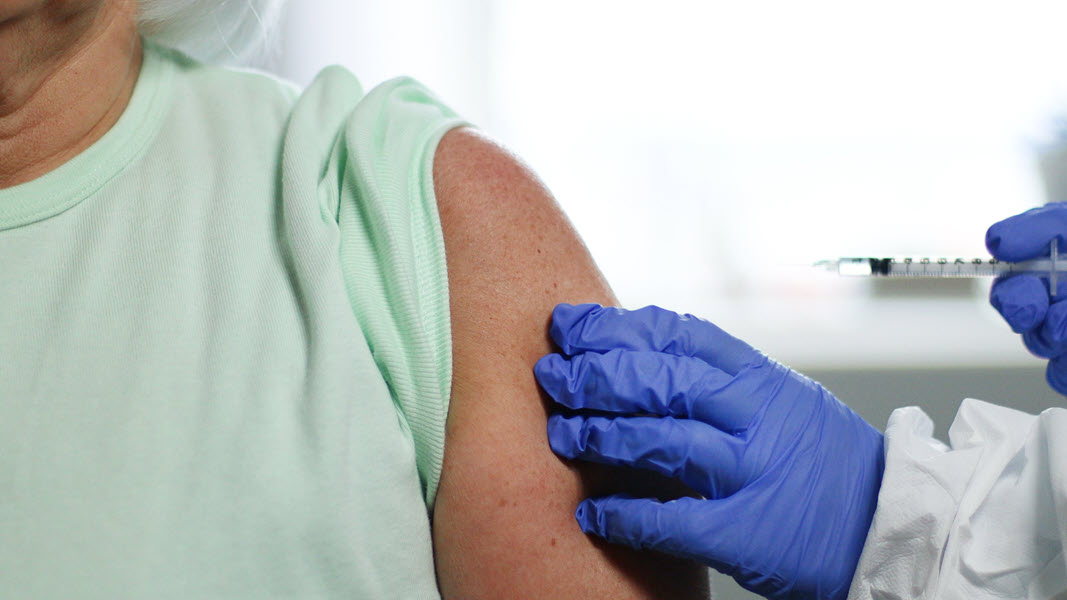 Provider giving a shot to a patient